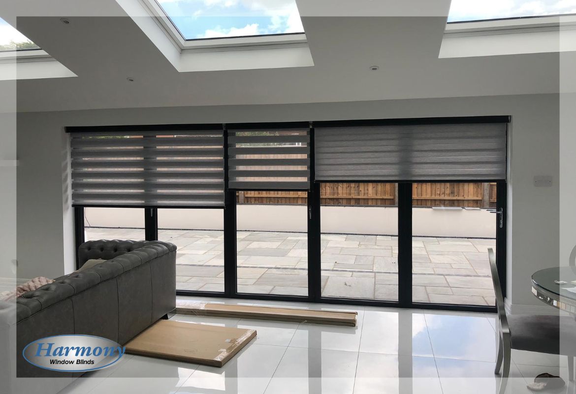 Three Grey Day and Night Blinds on Wide Bi-fold Doors