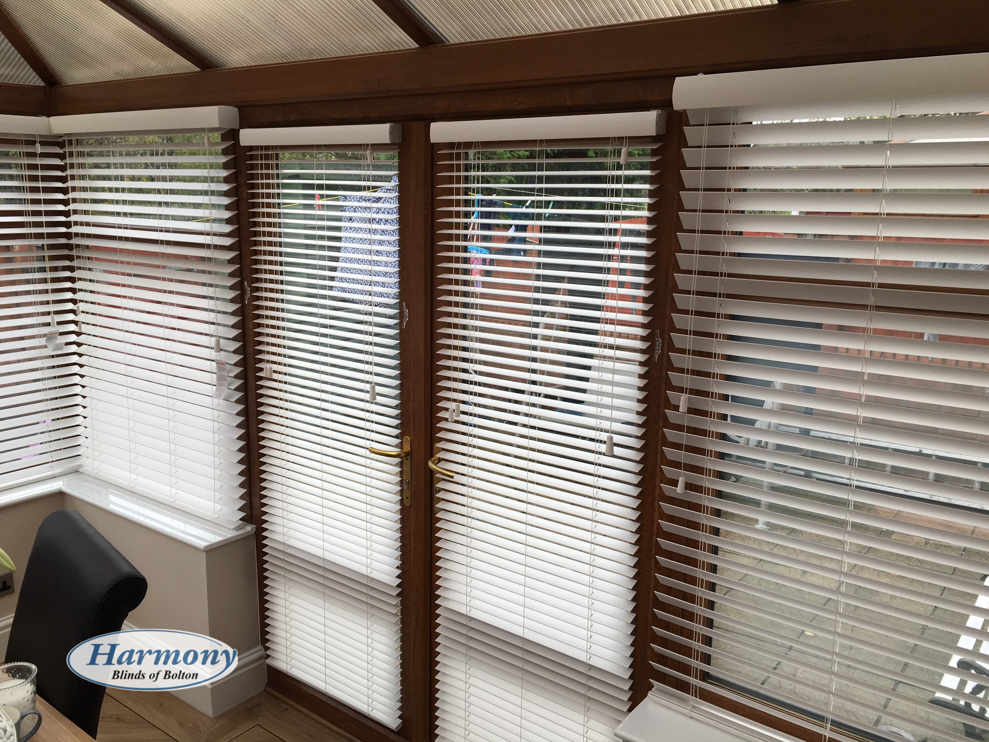 White Faux Wood Blinds in a Golden Oak Conservatory Harmony Blinds