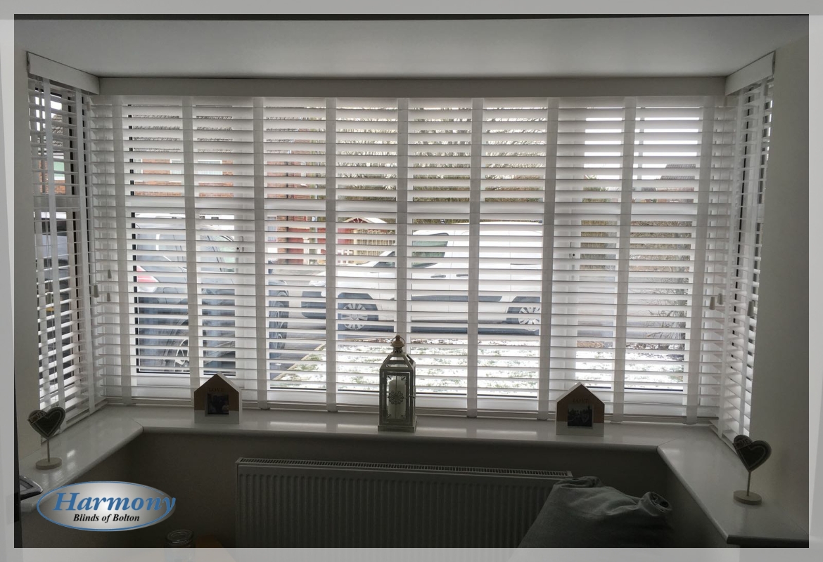 White FauxWood Blinds with Ladder Tapes in a Bay Window